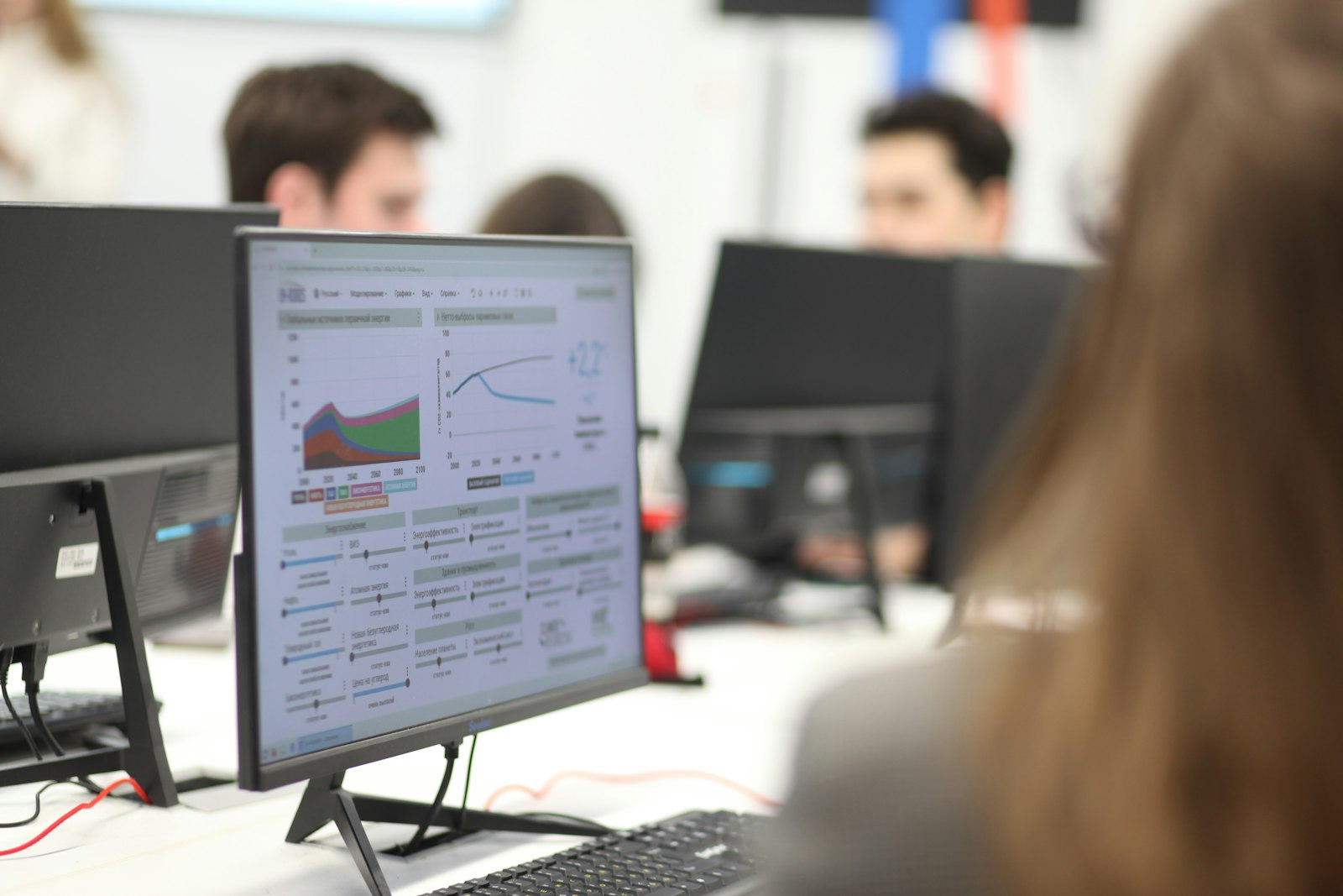 Team working with data dashboards on screens